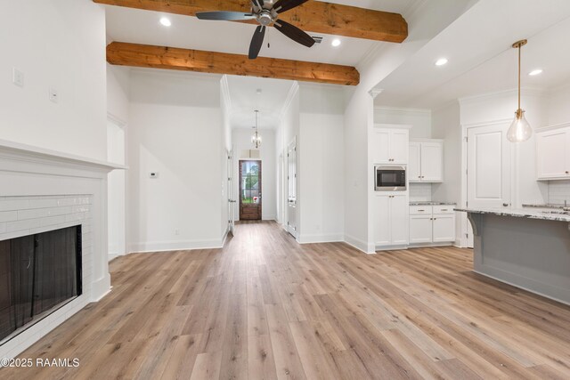 unfurnished living room with ceiling fan, beam ceiling, light wood-style floors, and recessed lighting
