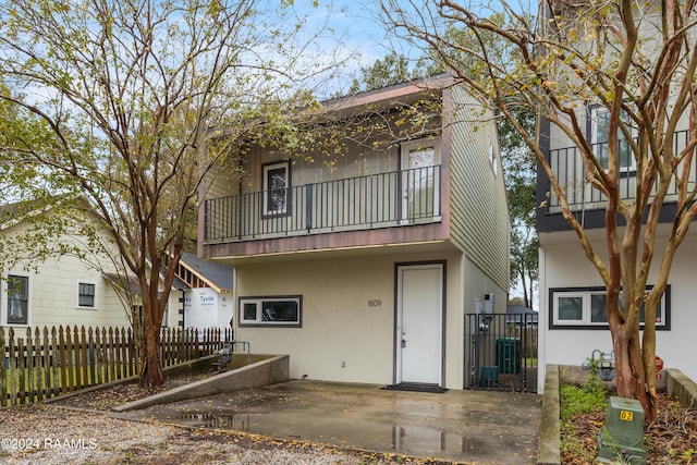 rear view of property with a balcony