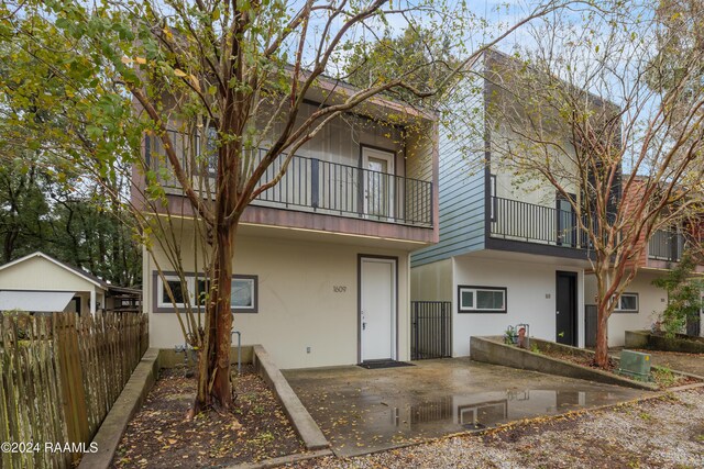 back of property with a balcony