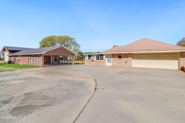 single story home with a garage and a carport