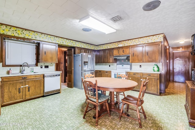 kitchen featuring sink and white appliances