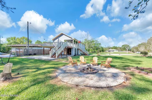 view of yard with a patio area, a trampoline, an outdoor fire pit, and a wooden deck