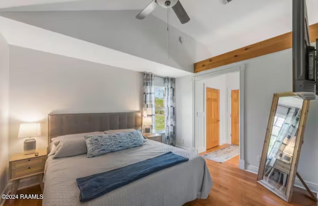 bedroom featuring ceiling fan, light hardwood / wood-style floors, and high vaulted ceiling