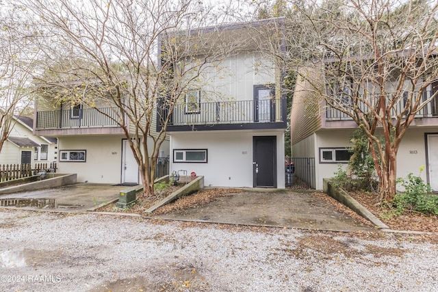 1611 W University Ave, Lafayette, LA 70506 - view of property featuring a balcony and stucco siding