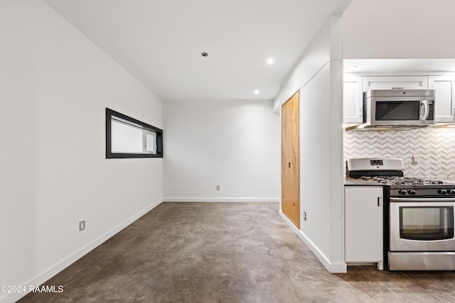 1611 W University Ave, Lafayette, LA 70506 - kitchen featuring appliances with stainless steel finishes, concrete floors, white cabinets, tasteful backsplash, and recessed lighting
