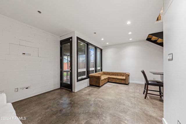 1611 W University Ave, Lafayette, LA 70506 - living room with concrete flooring, recessed lighting, and concrete block wall