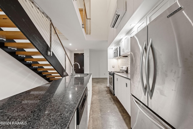 1611 W University Ave, Lafayette, LA 70506 - kitchen with appliances with stainless steel finishes, a wall unit AC, recessed lighting, tasteful backsplash, and white cabinets