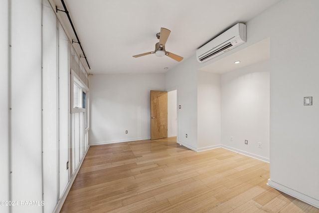 unfurnished bedroom with ceiling fan, lofted ceiling, a wall unit AC, and light hardwood / wood-style flooring