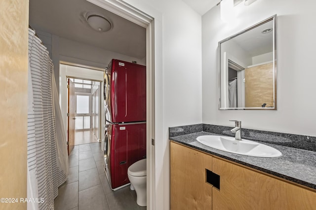 1611 W University Ave, Lafayette, LA 70506 - full bathroom with stacked washing machine and dryer, vanity, and tile patterned floors