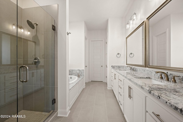 bathroom featuring tile patterned flooring, shower with separate bathtub, and vanity