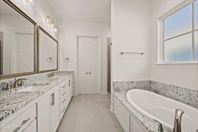 bathroom featuring tile patterned flooring, vanity, independent shower and bath, and a wealth of natural light