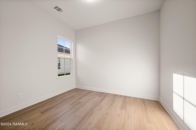 unfurnished room with light wood-type flooring