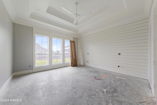 spare room with ceiling fan, crown molding, and a tray ceiling