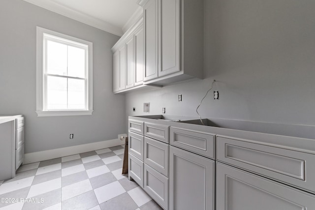 laundry area with crown molding, cabinets, and hookup for an electric dryer