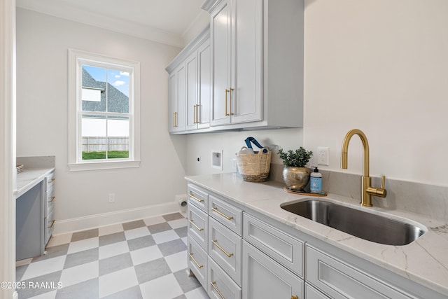 washroom with light floors, hookup for an electric dryer, cabinet space, a sink, and washer hookup