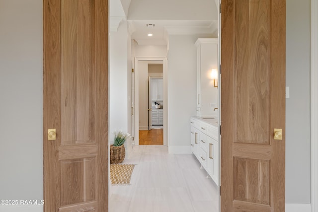 bathroom with vanity, visible vents, and baseboards