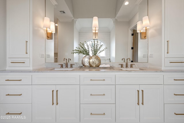 full bathroom with double vanity, visible vents, and a sink