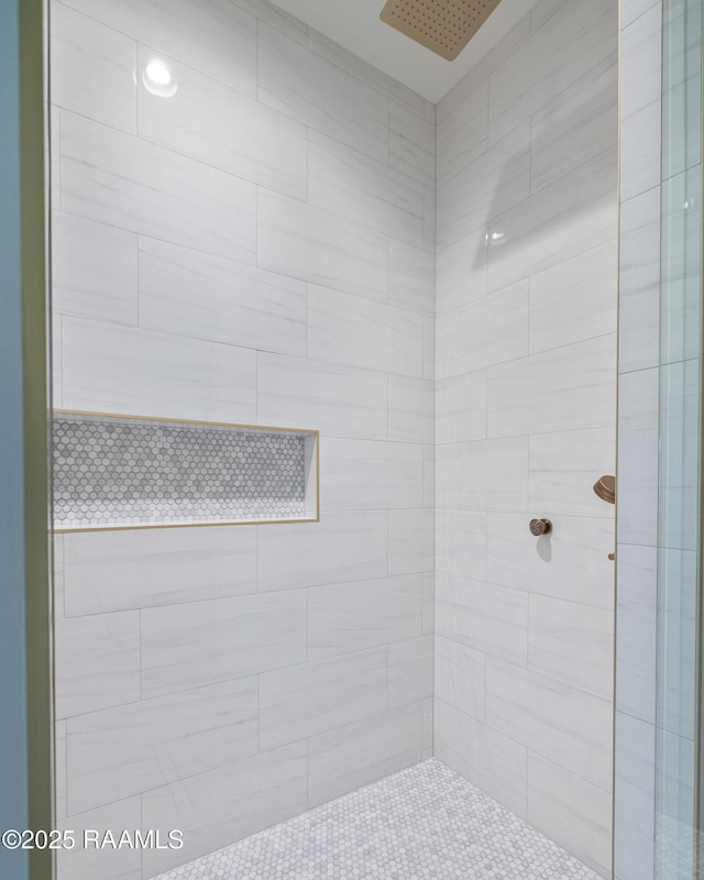 bathroom with a tile shower