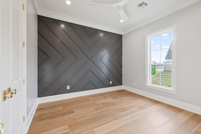 spare room with visible vents, baseboards, and light wood-style flooring