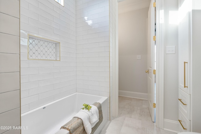 bathroom featuring baseboards and a washtub