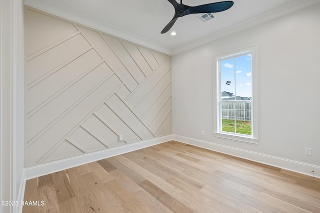 spare room with baseboards, visible vents, and light wood finished floors