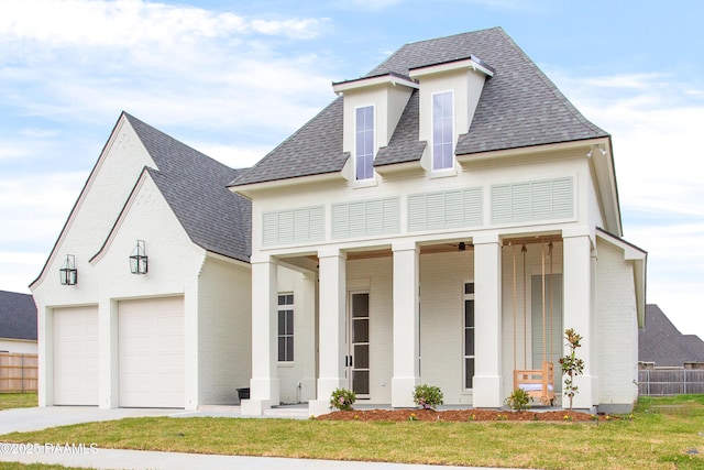 view of front of home featuring a porch, fence, a front yard, a shingled roof, and brick siding