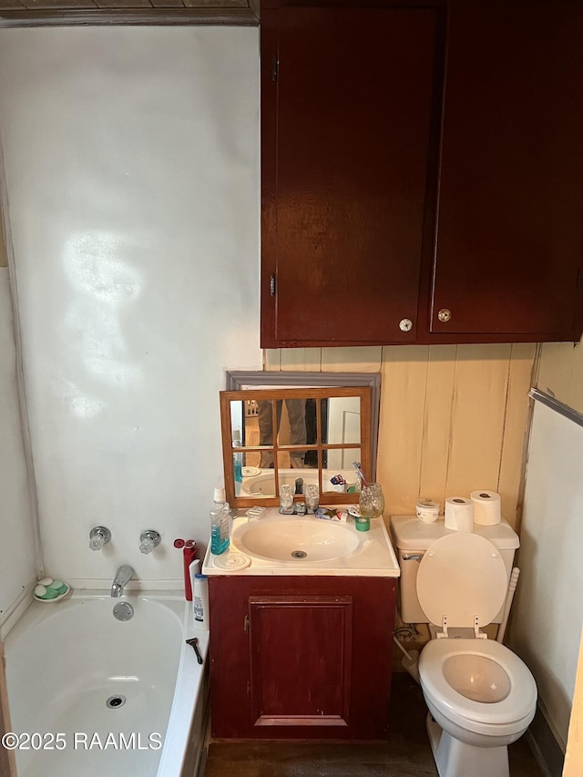 bathroom with a bathing tub, vanity, and toilet