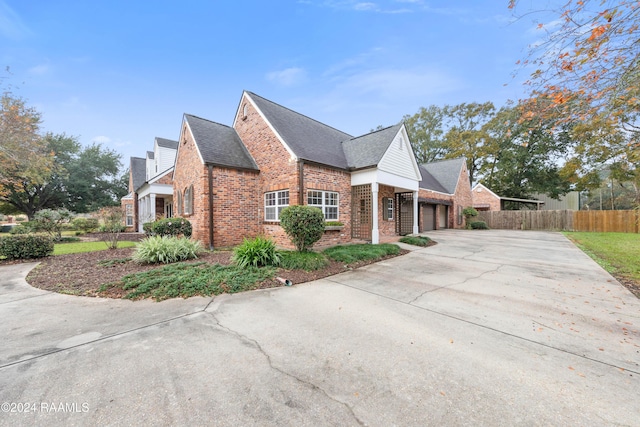 1013 Bayou Bend Cir, Breaux Bridge, LA 70517 - view of side of home featuring brick siding, driveway, a garage, and roof with shingles