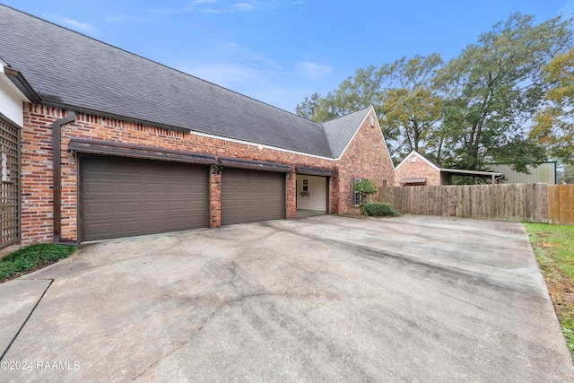 1013 Bayou Bend Cir, Breaux Bridge, LA 70517 - view of side of property with brick siding, concrete driveway, roof with shingles, and a garage
