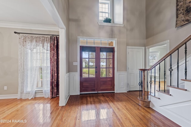 entrance foyer featuring plenty of natural light, hardwood / wood-style floors, and french doors