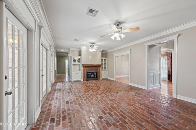 unfurnished living room featuring ceiling fan, a healthy amount of sunlight, and ornamental molding