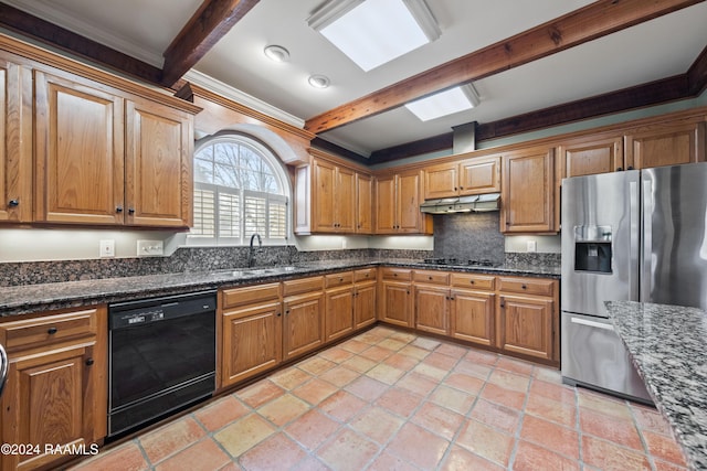 kitchen featuring black appliances, sink, dark stone countertops, ornamental molding, and beam ceiling