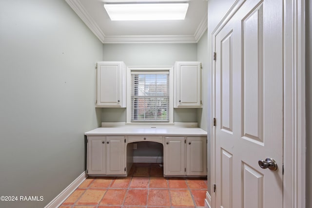 unfurnished office with built in desk and ornamental molding