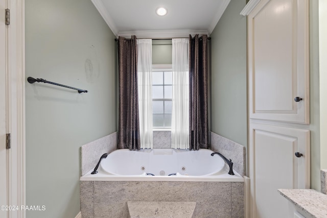bathroom with a relaxing tiled tub and ornamental molding