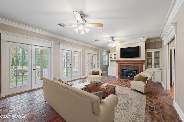 living room with crown molding, french doors, and ceiling fan