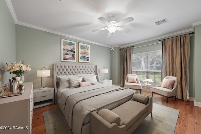 bedroom featuring ceiling fan, crown molding, and hardwood / wood-style flooring