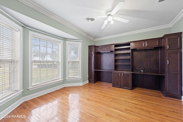 unfurnished office with ornamental molding, light wood-type flooring, and a healthy amount of sunlight