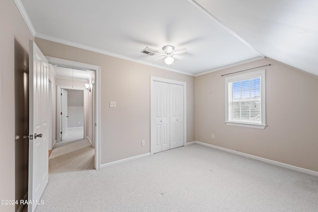 unfurnished bedroom featuring ornamental molding, light colored carpet, ceiling fan, and lofted ceiling