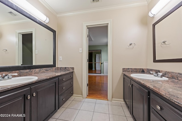 1013 Bayou Bend Cir, Breaux Bridge, LA 70517 - bathroom with two vanities, tile patterned floors, and crown molding