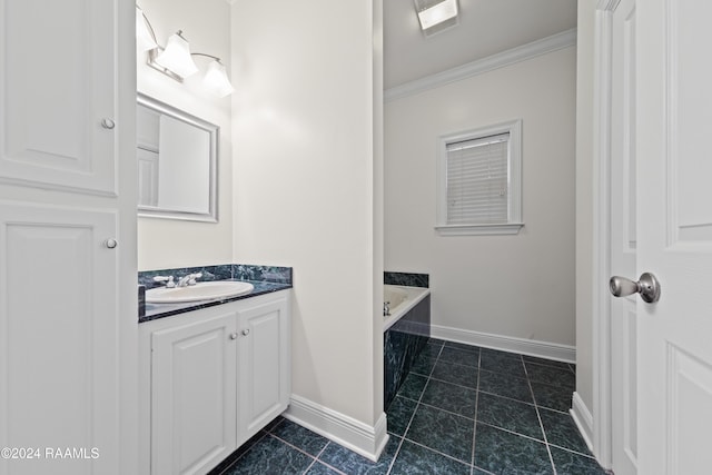 bathroom featuring vanity, tile patterned floors, a bathtub, and crown molding
