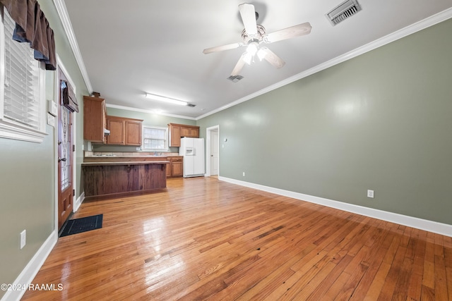 kitchen featuring crown molding, ceiling fan, white fridge with ice dispenser, light hardwood / wood-style floors, and kitchen peninsula