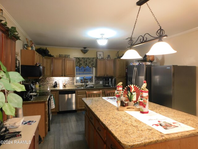 2001 Segura Rd, New Iberia, LA 70560 - kitchen featuring stainless steel dishwasher, decorative backsplash, a kitchen island, and hanging light fixtures