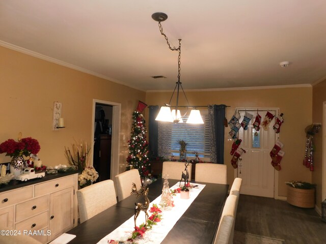 2001 Segura Rd, New Iberia, LA 70560 - dining room with dark hardwood / wood-style flooring, crown molding, and a notable chandelier