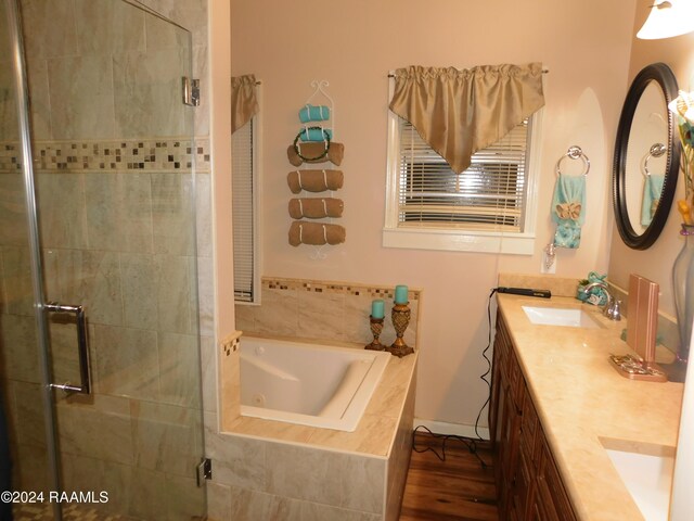2001 Segura Rd, New Iberia, LA 70560 - bathroom with shower with separate bathtub, vanity, and hardwood / wood-style floors