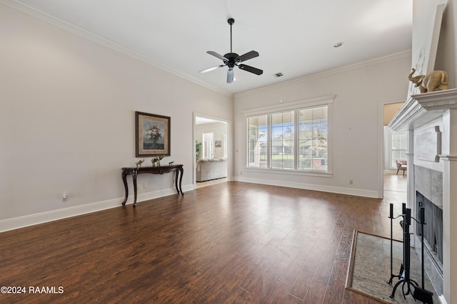 unfurnished living room with a premium fireplace, ceiling fan, dark hardwood / wood-style floors, and ornamental molding