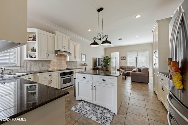 kitchen featuring stainless steel appliances, a kitchen island, decorative light fixtures, light tile patterned flooring, and ornamental molding