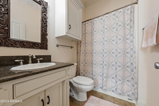 bathroom featuring tile patterned flooring, vanity, toilet, and crown molding