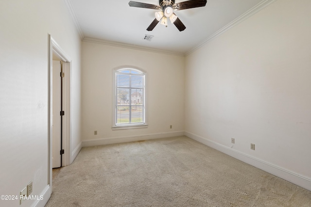 empty room featuring light carpet, ceiling fan, and ornamental molding