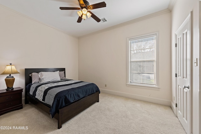 carpeted bedroom featuring ceiling fan and ornamental molding