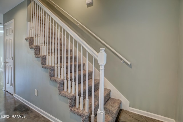 stairway featuring concrete floors